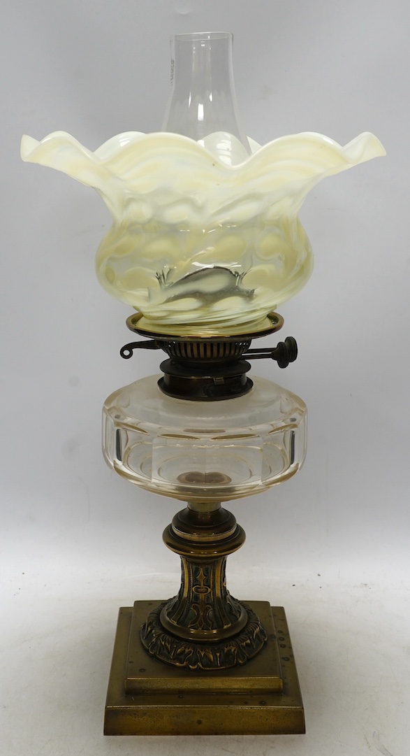 A brass oil lamp with glass reservoir and vaseline glass fluted shade, 48cm high. Condition - good